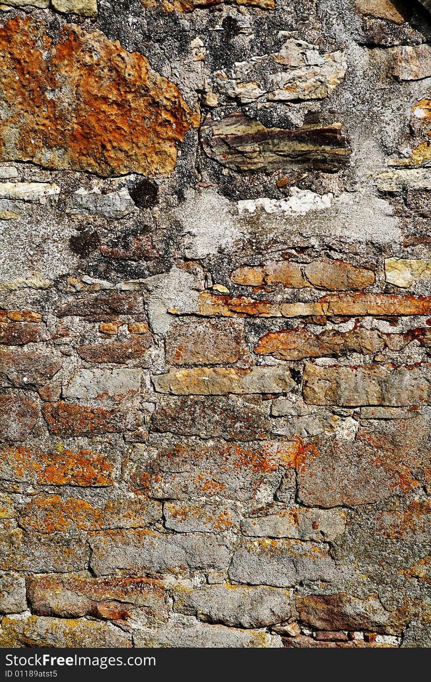 A very old wall build of natural stones. A very old wall build of natural stones