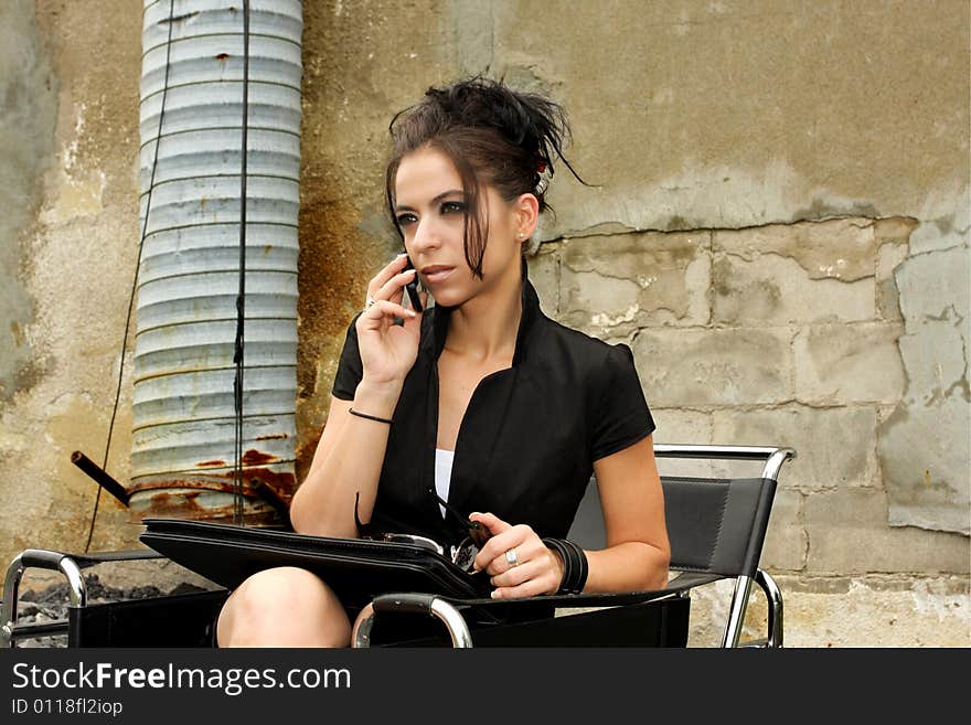 Pretty women on the phone outside her office. Pretty women on the phone outside her office