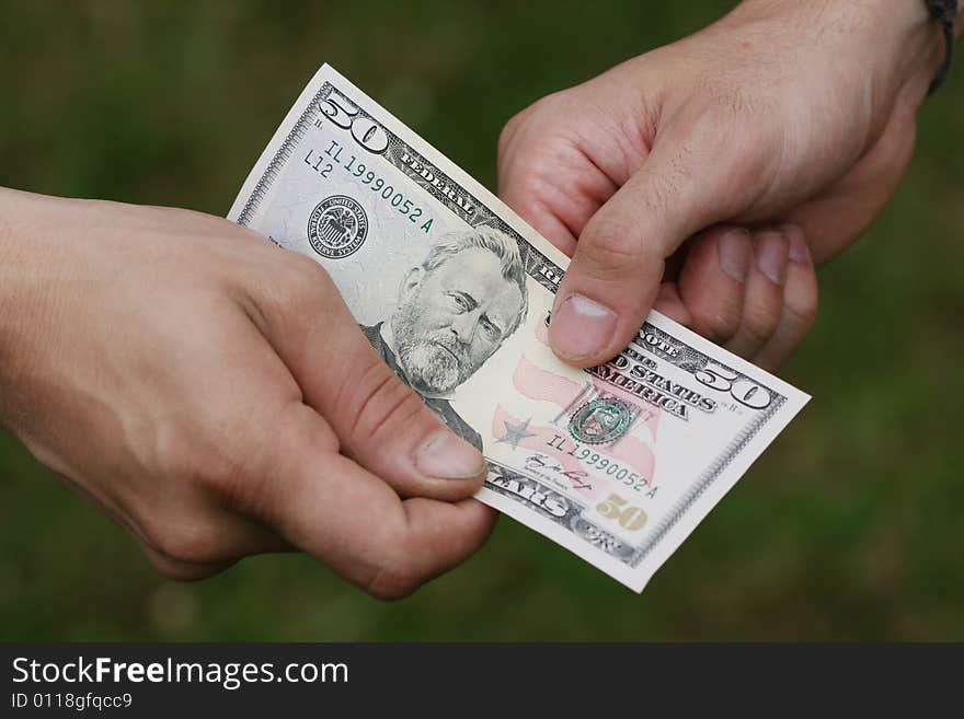 Two man´s hands with fifty dollars. Two man´s hands with fifty dollars