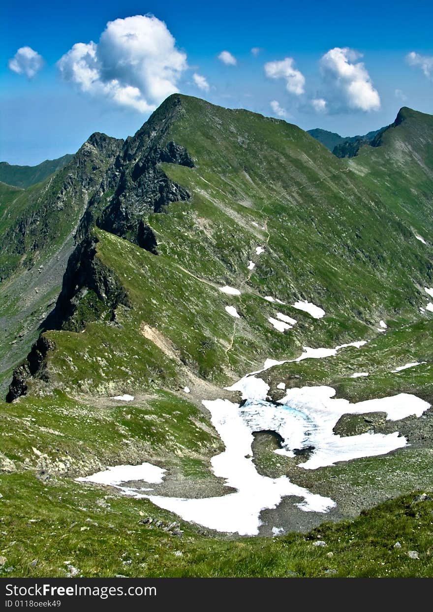 The lake Podu Giurgiului is situated at 2264 m altitude, in Fagaras moutains. Is one of the highest altitude lakes from Romania. In background you see Podragu peak, with 2462 m altitude. The lake Podu Giurgiului is situated at 2264 m altitude, in Fagaras moutains. Is one of the highest altitude lakes from Romania. In background you see Podragu peak, with 2462 m altitude.