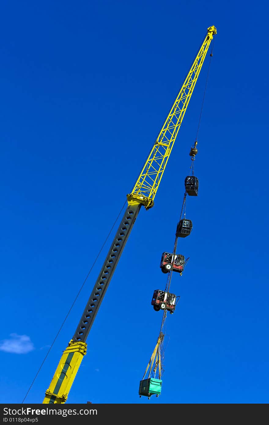 Crane on construction site pulling up equipment