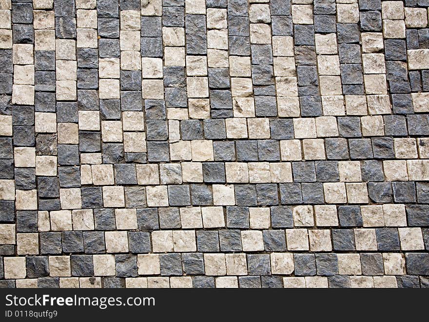 Stone design in Prague sidewalk. Background texture.