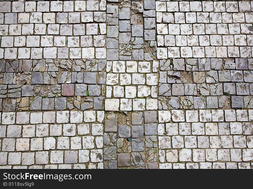 Stone design in Prague sidewalk. Background texture.