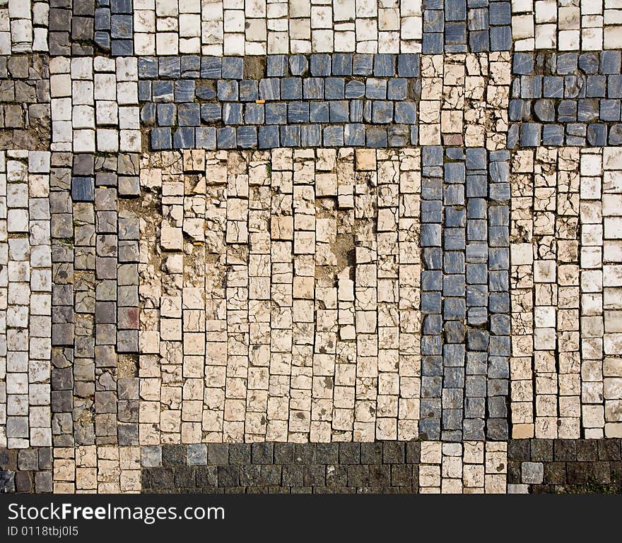 Stone design in Prague sidewalk. Background texture.