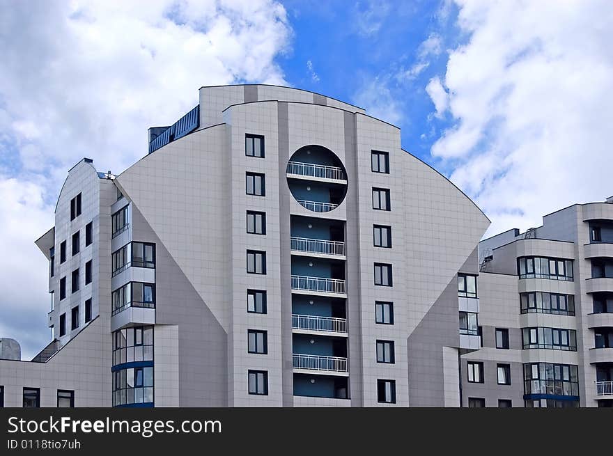 Modern office building on blue sky background