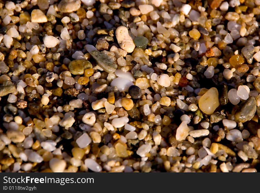 Small wet stones at the sea shore. Small wet stones at the sea shore