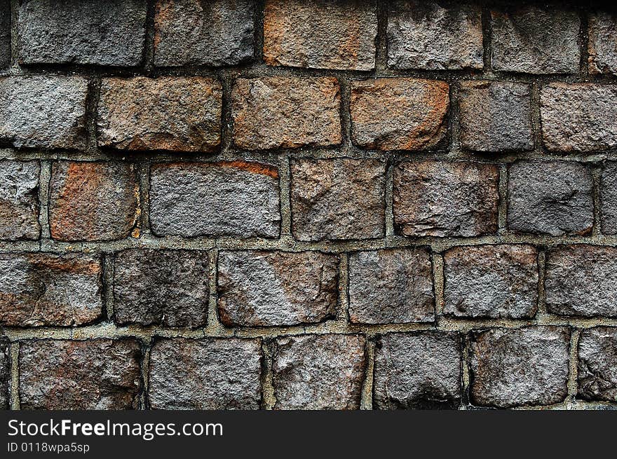 Old weathered black stones wall. Old weathered black stones wall