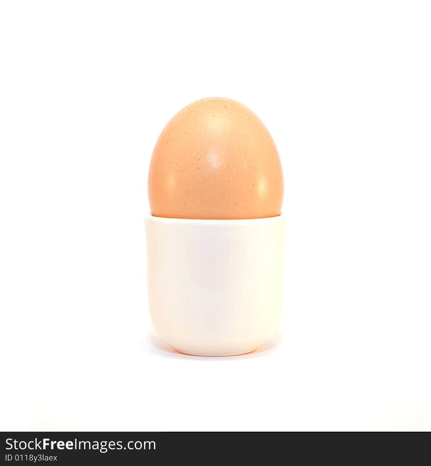 An egg in a cup on a solid white background