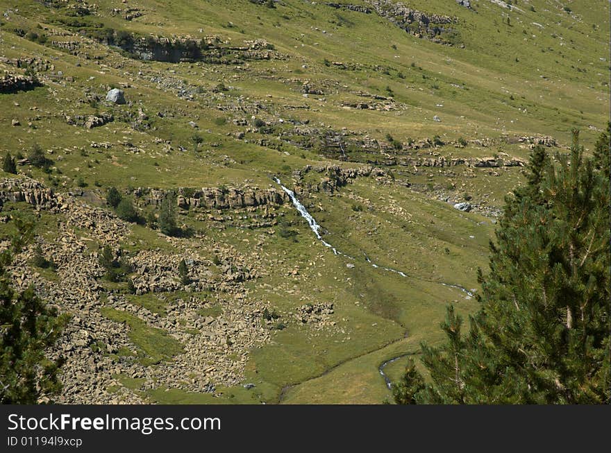 Hillside with waterfall.