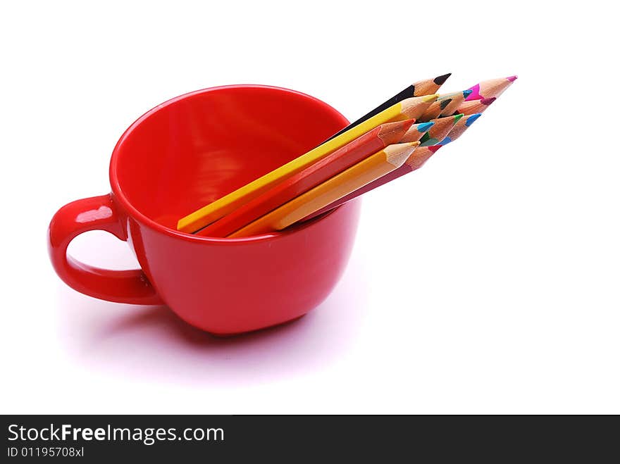 Colorful pencils in the red cup isolated on white background