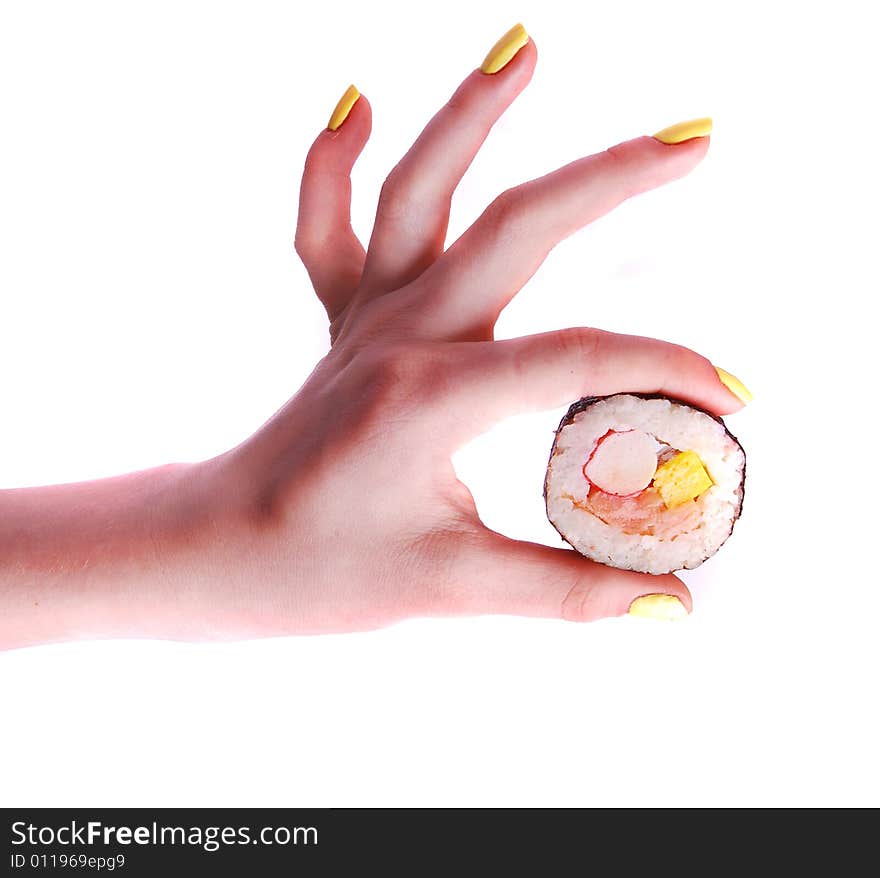 Sushi roll in a hand isolated on white