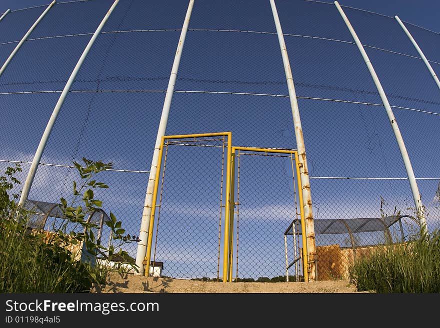 Wire fence and gate of local football  playground. Wire fence and gate of local football  playground.