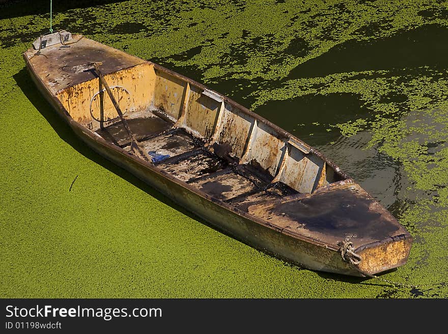 Old metal boat in green water field. Old metal boat in green water field