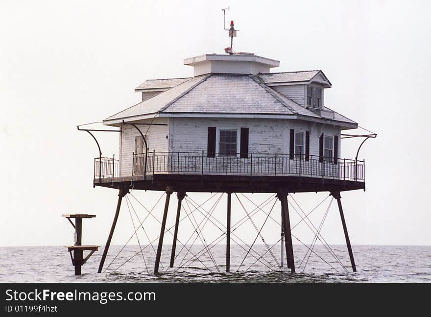 Photo of a lighthouse in the middle of Mobile Bay.