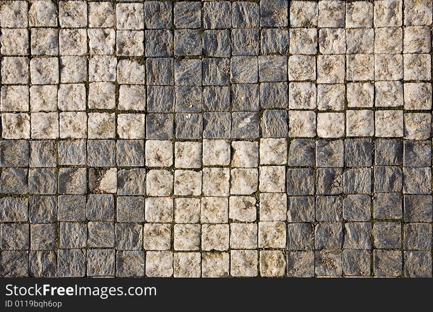 Stone design in Prague sidewalk. Background texture.