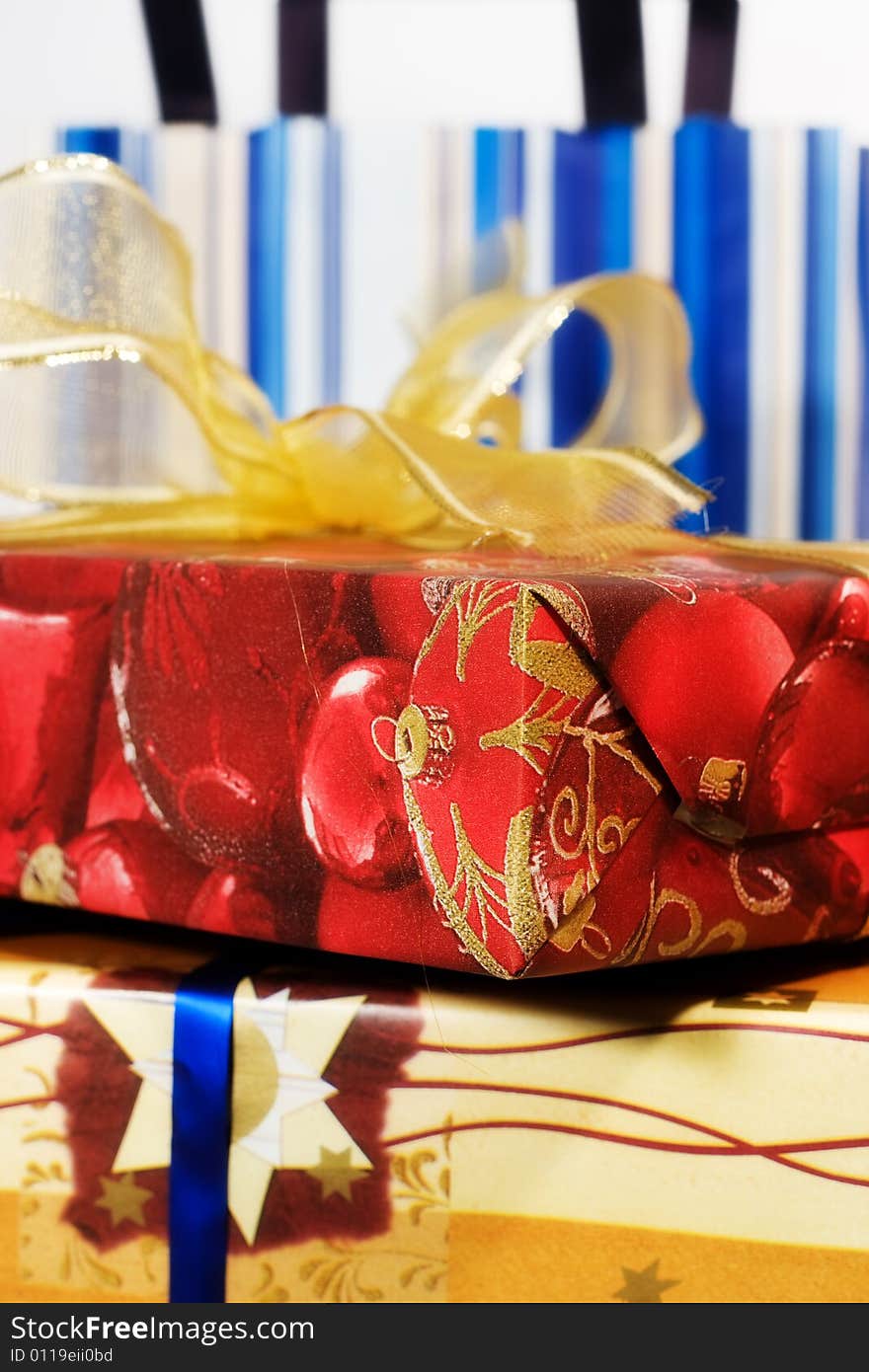 Red gift box with golden ribbon and paper bags. Red gift box with golden ribbon and paper bags