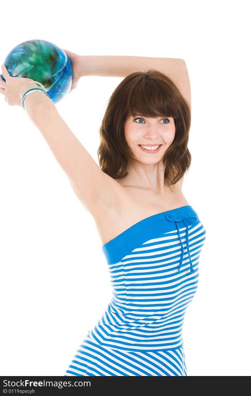 Smiling girl in the blue dress throwing ball