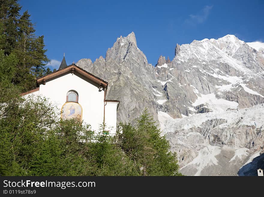 Small mountain church; in background the south side of Mont Blanc, Courmayeur, Italy.