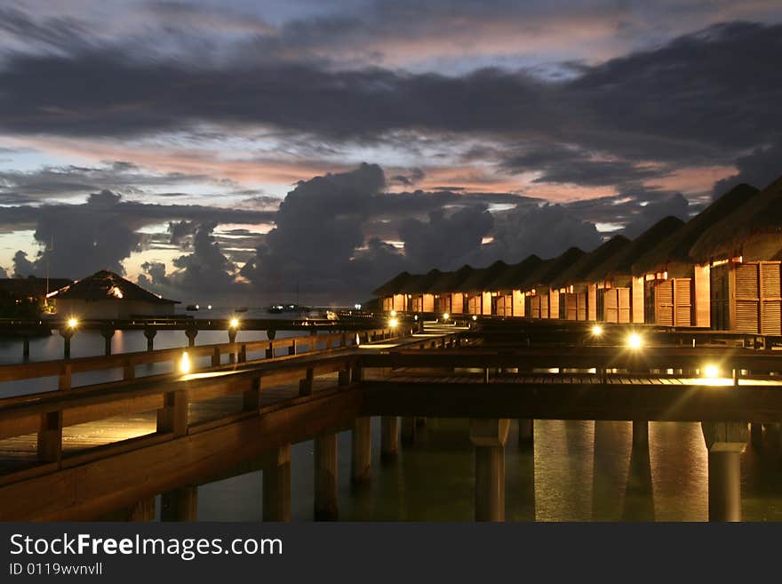 Water bungalow of the full moon island maldives at nightfall.