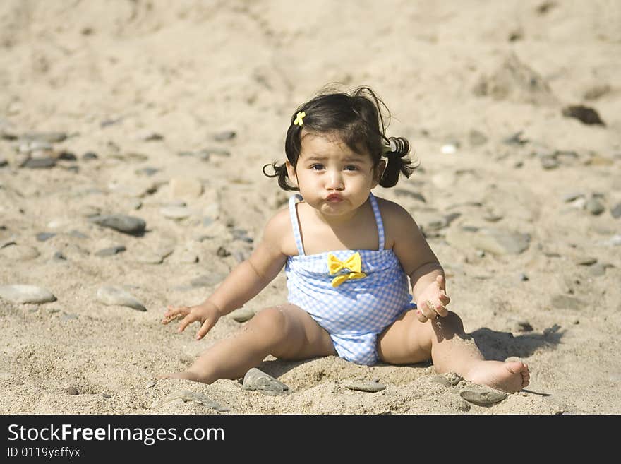 Girl making a funny face while playing at the beach. Girl making a funny face while playing at the beach.