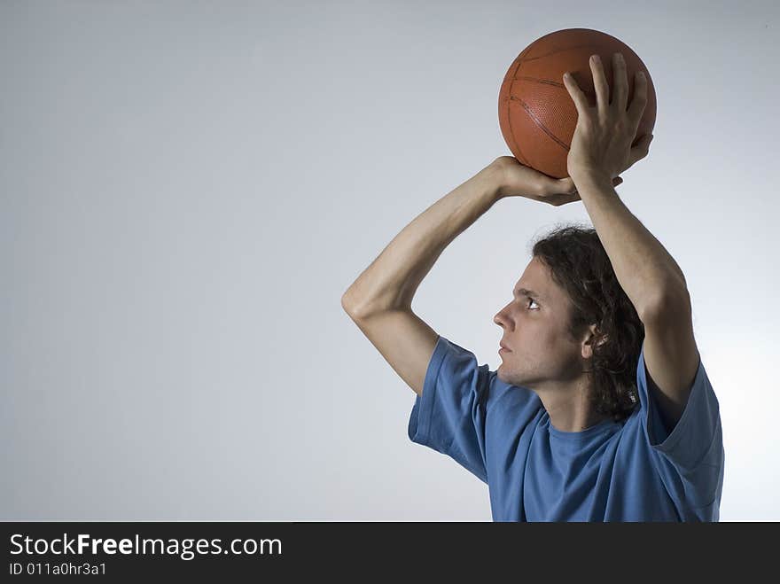 Man shooting a basketball. Horizontally framed photograph. Man shooting a basketball. Horizontally framed photograph