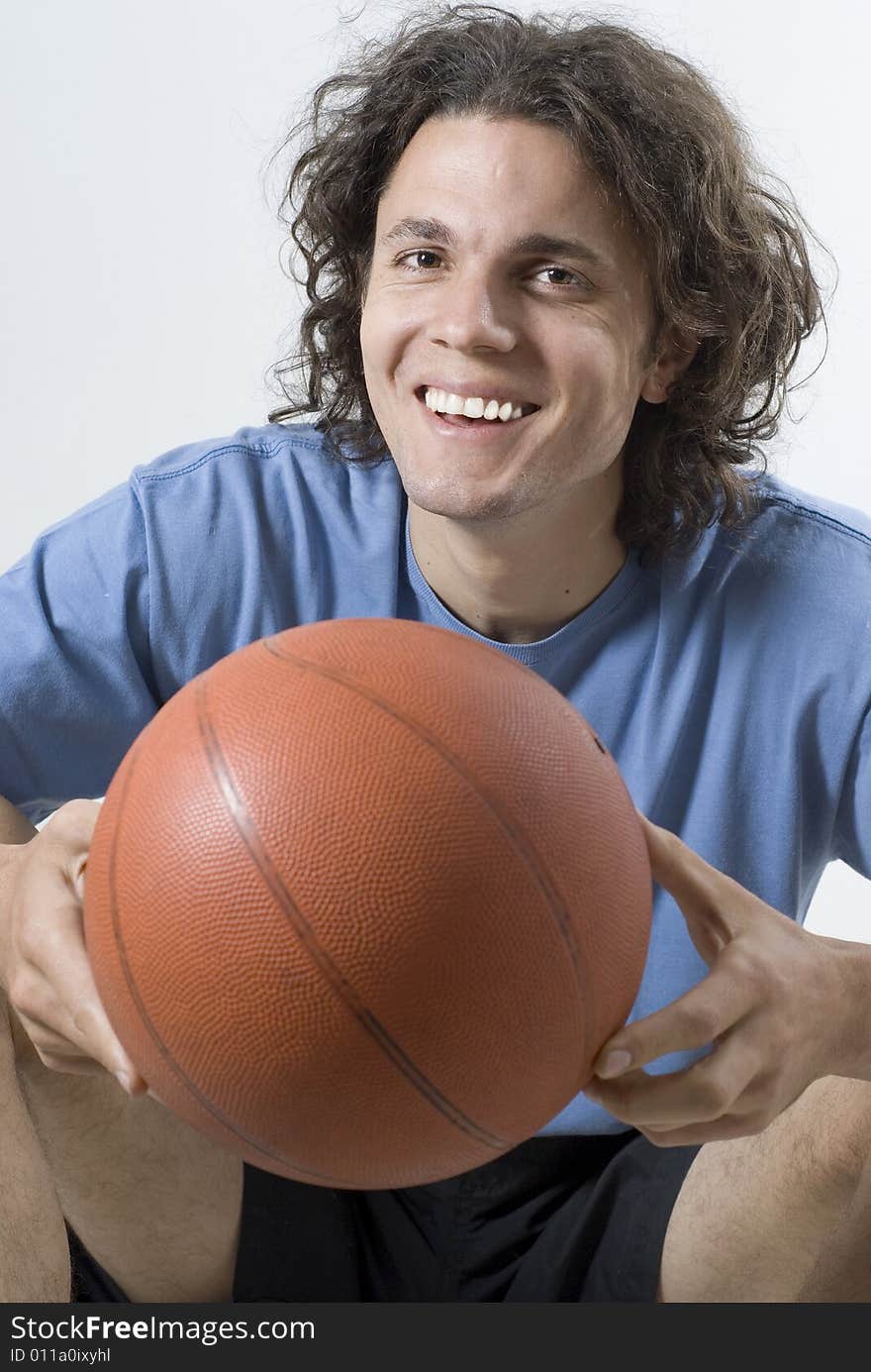 Man Sitting Holding a Basketball - Vertical