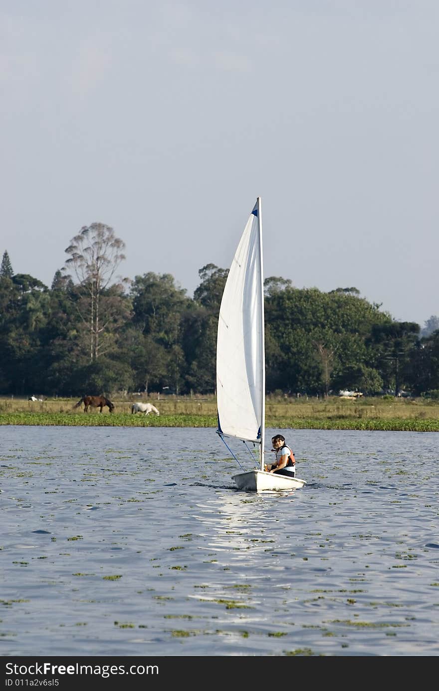 Man and Woman Sitting on Sailboat - Vertical