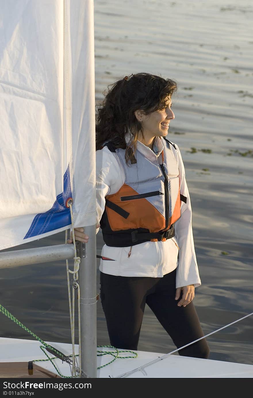 Woman Standing Next to Sailboat - Vertical