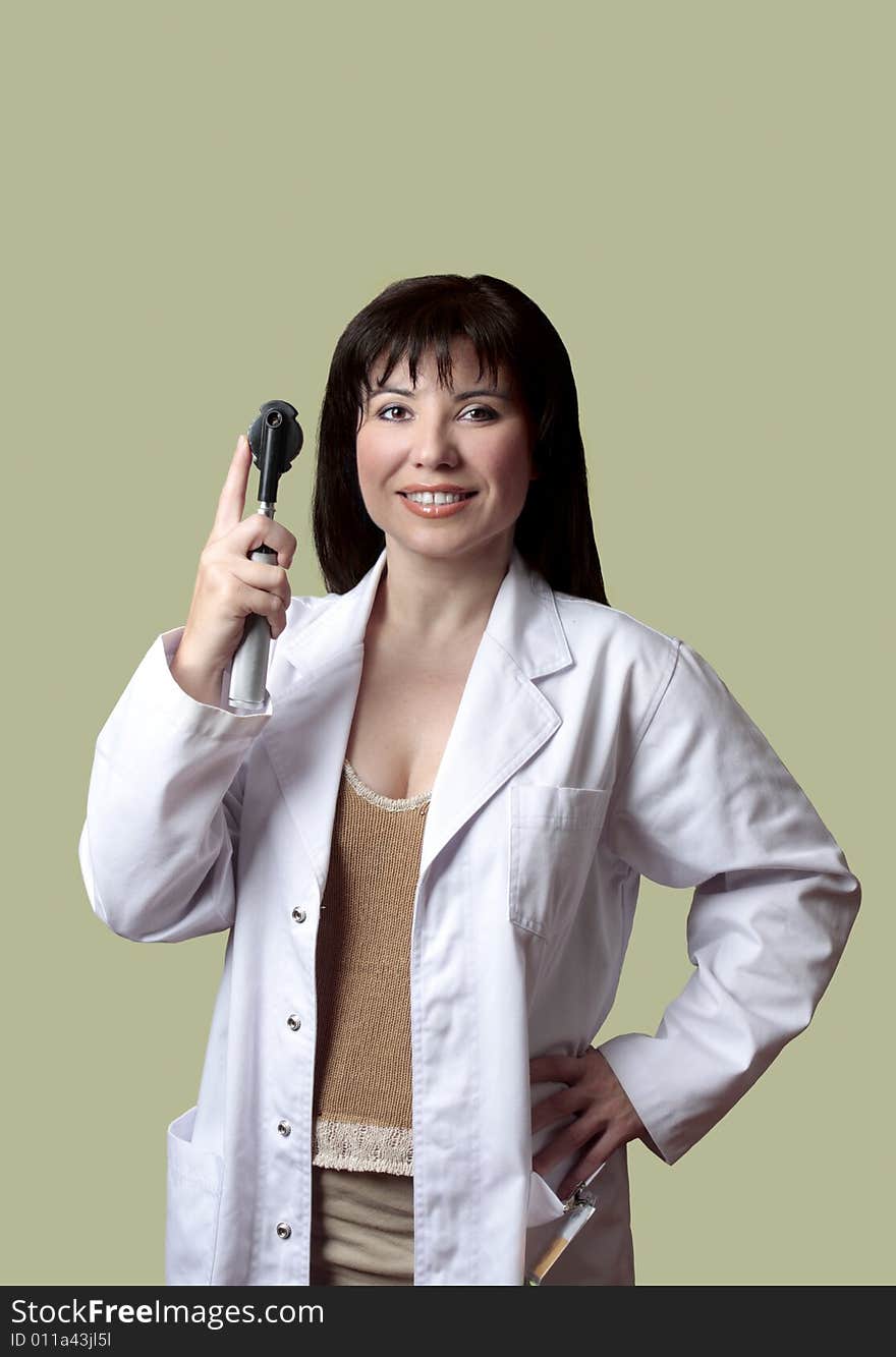 Optometrist wearing a doctors coat and holding an opthalmoscope  instrument.  copyspace.