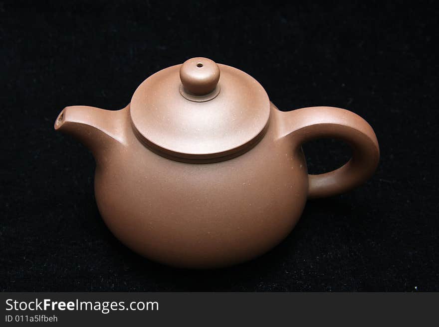 An teapot isolated on black background from China.