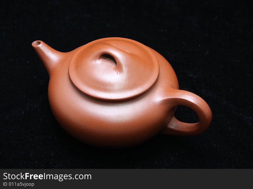 An teapot isolated on black.