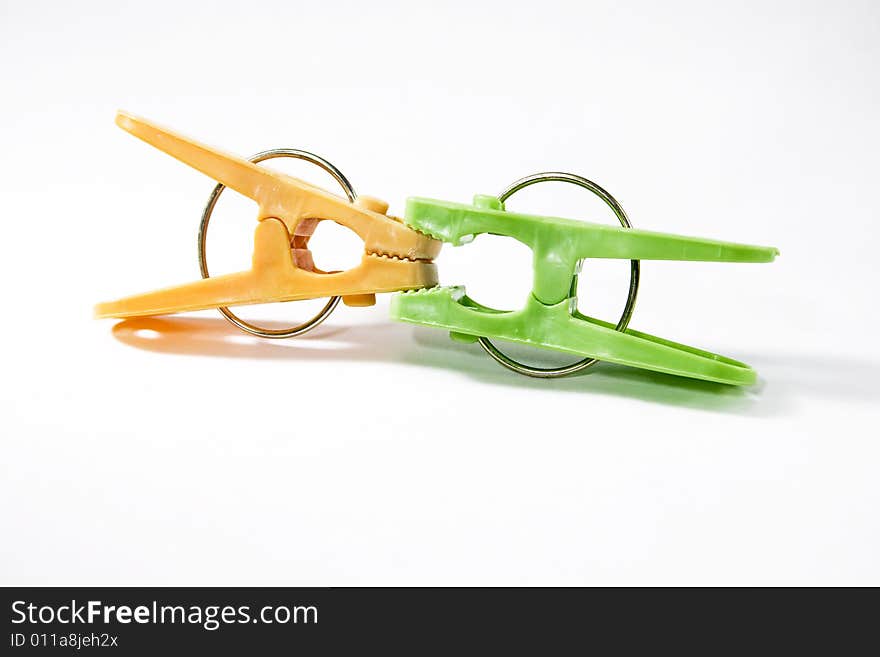 Two clothes pegs (orange and green)