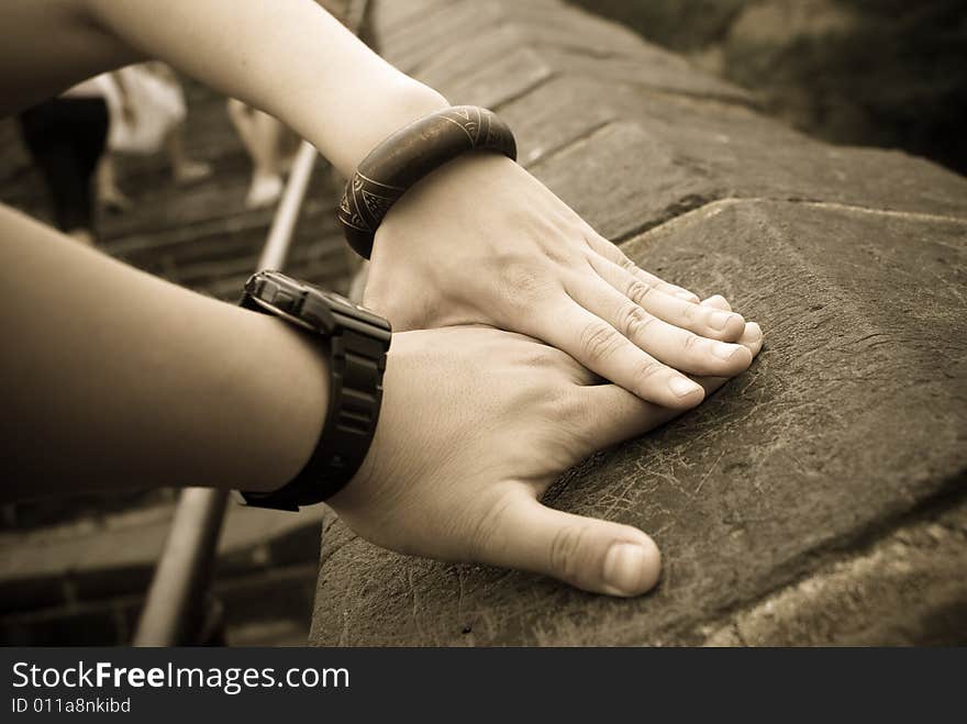 A couple put their hands together on the great wall in China to show their confident love.