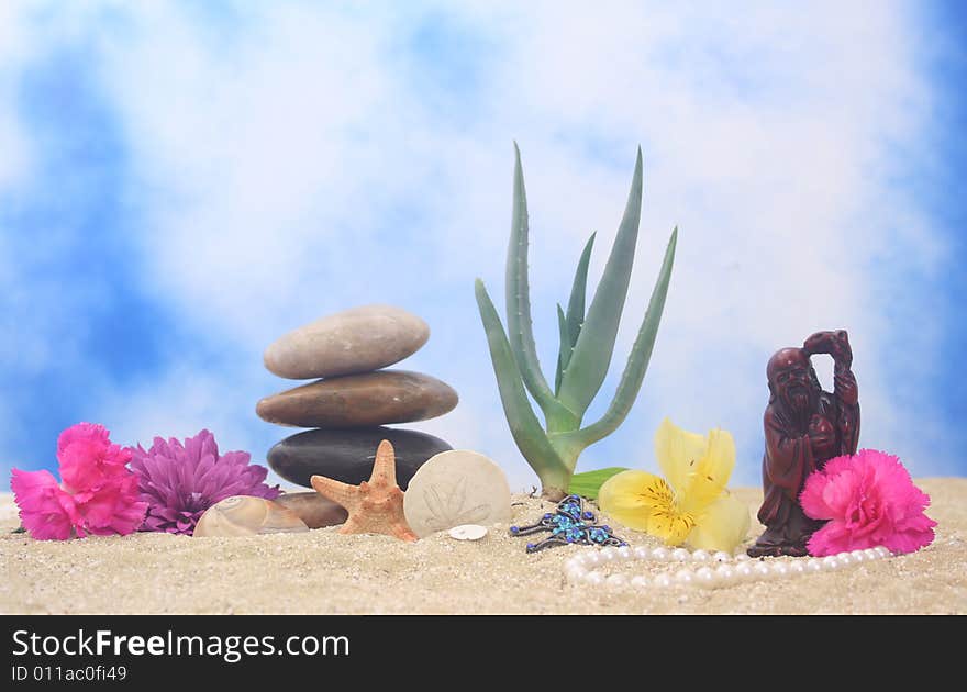 Aloe Vera and Buddha on Sand With Blue Background. Aloe Vera and Buddha on Sand With Blue Background