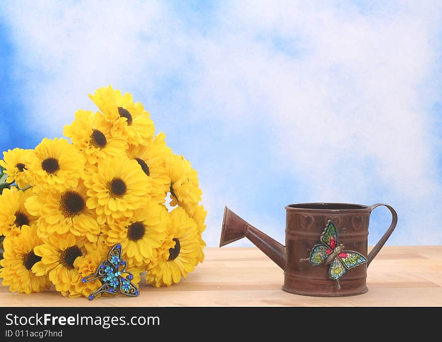 Yellow Flowers and Metal Water Can on Blue Textured Background. Yellow Flowers and Metal Water Can on Blue Textured Background