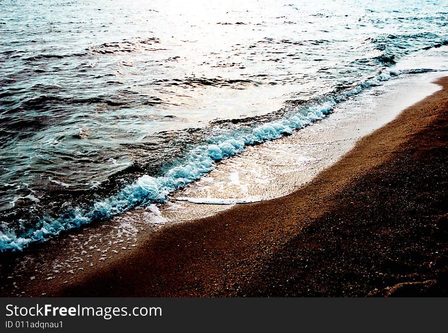 Sun reflected in the sea and some wet sand. Sun reflected in the sea and some wet sand