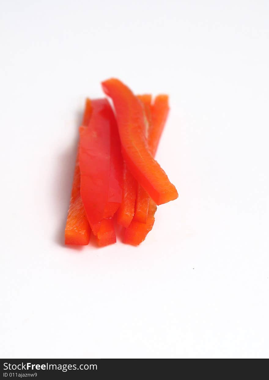 Sliced red pepper in sticks, on white background