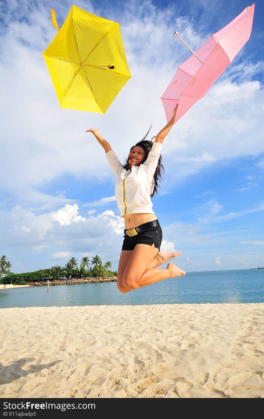 Jumping Girl on the beach with umbrellas. Jumping Girl on the beach with umbrellas.