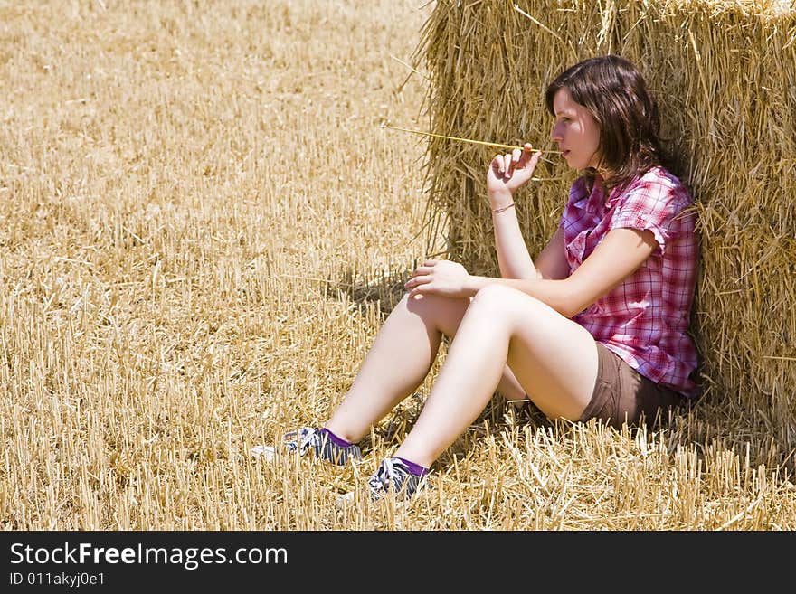 Young farmer resting on the haystack. Young farmer resting on the haystack