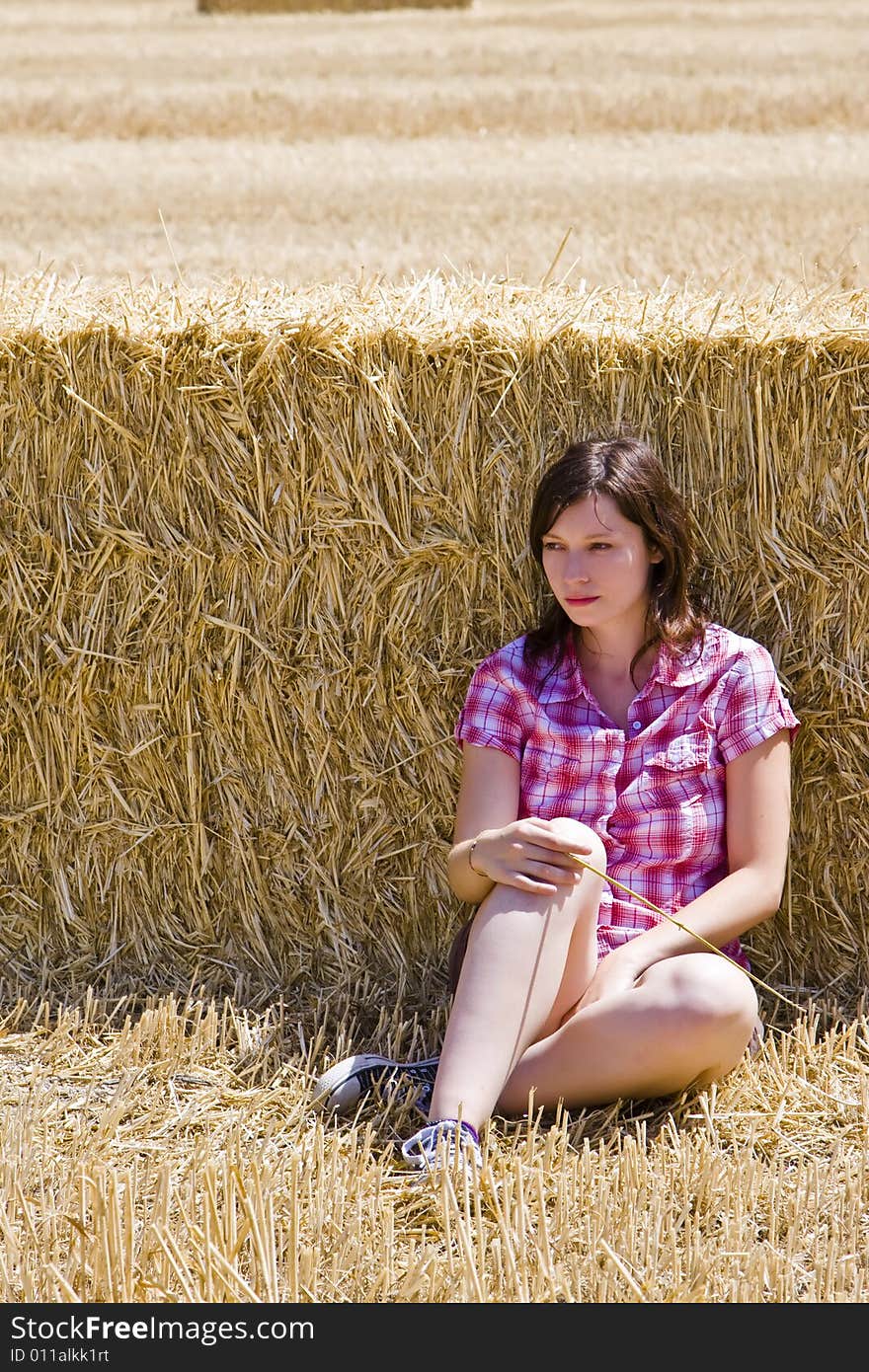 Young woman in haystack