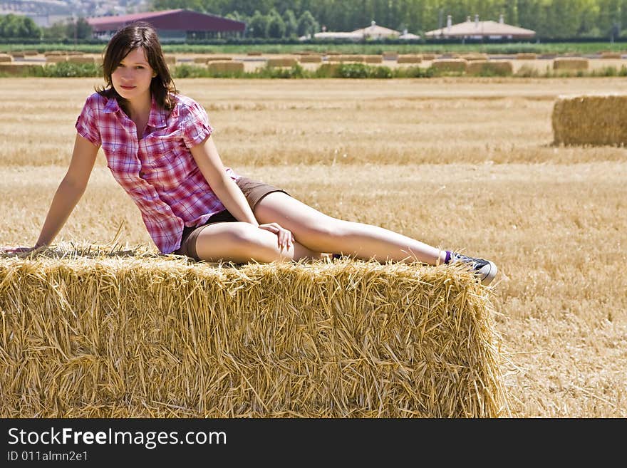 Young woman in haystack