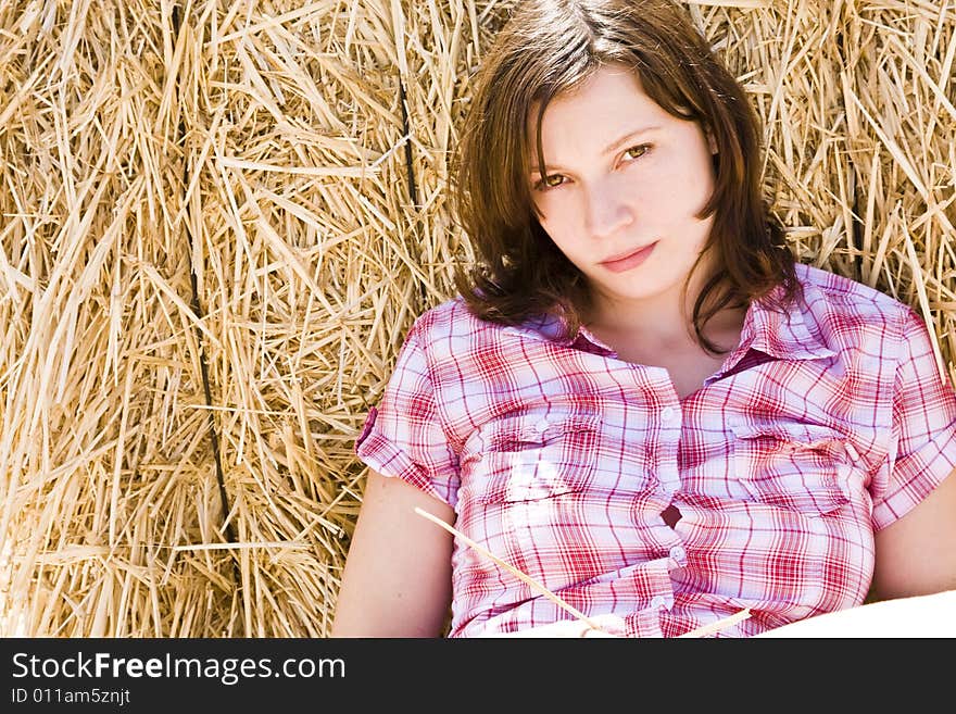 Young farmer resting on the haystack. Young farmer resting on the haystack