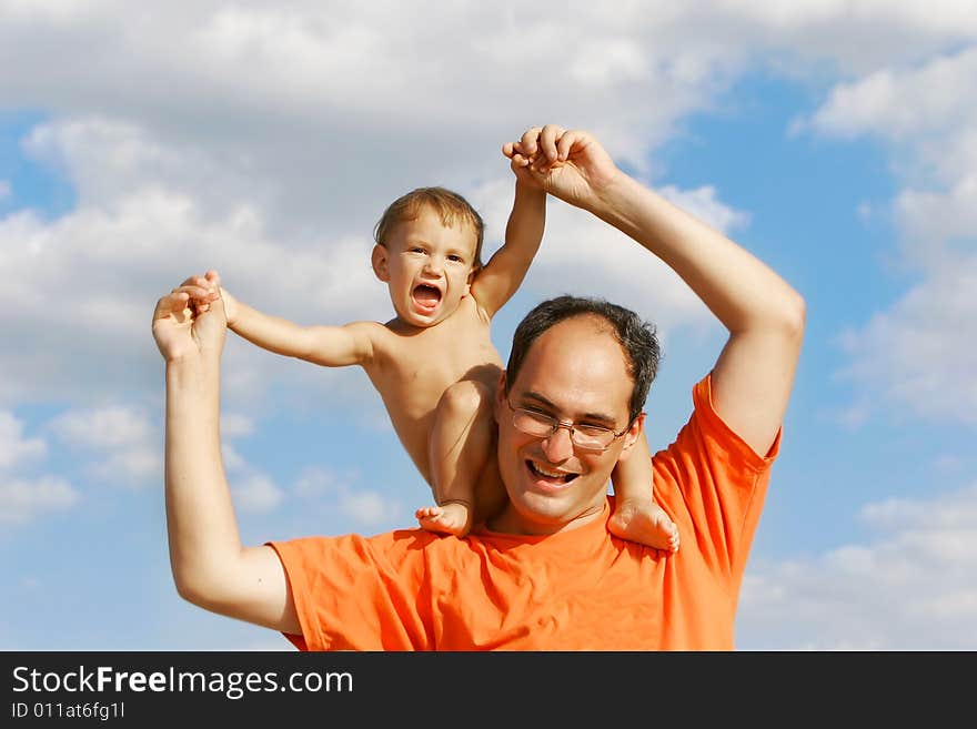 Father and son on sky background