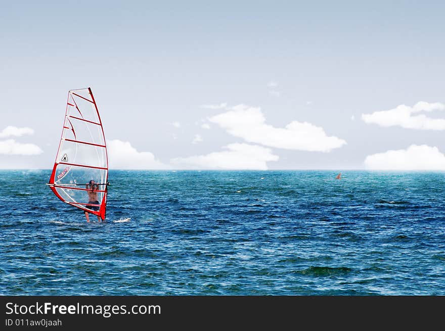 Image of a wind surfer on the waves of the sea. Image of a wind surfer on the waves of the sea