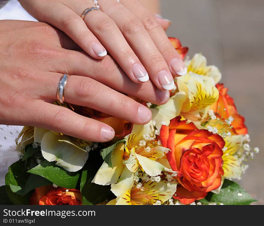 Newly-weds holding a wedding bouquet