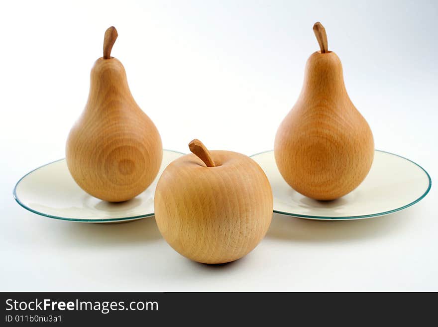 Wooden pears with an apple