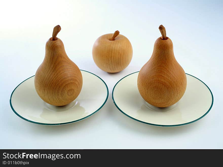 Wooden pears and an apple