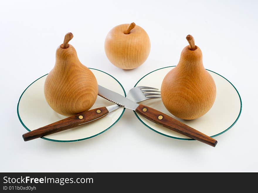 Wooden pears and an apple