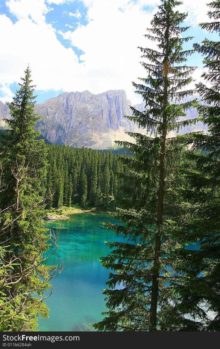 Sella mountain group, Carezza turquoise water lake.  green valley and  woods. Italy. Sella mountain group, Carezza turquoise water lake.  green valley and  woods. Italy