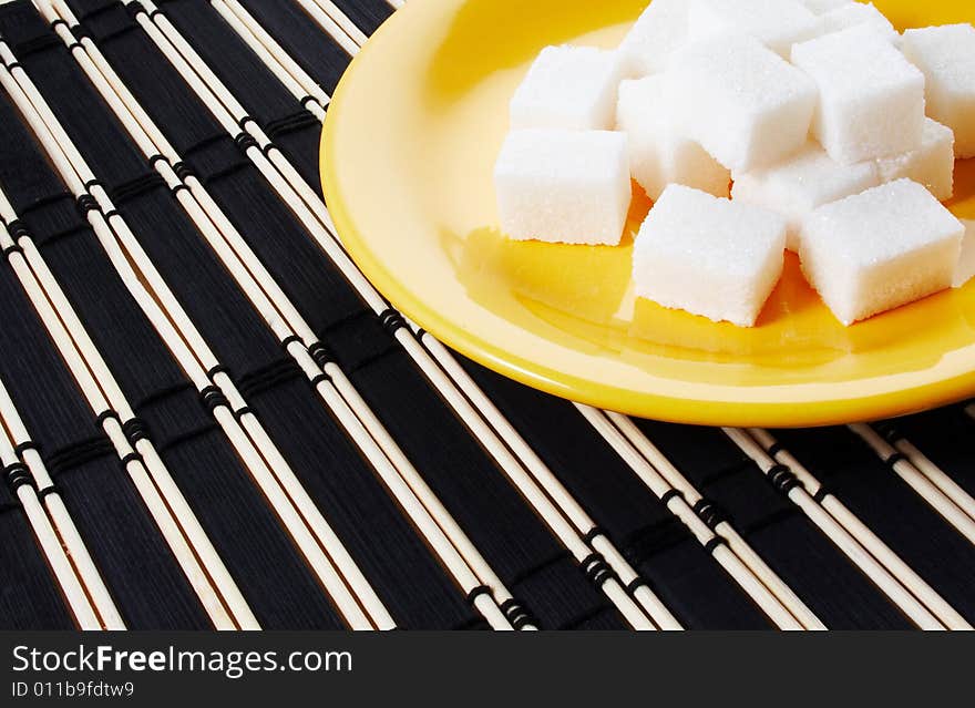 Sugar on a yellow saucer